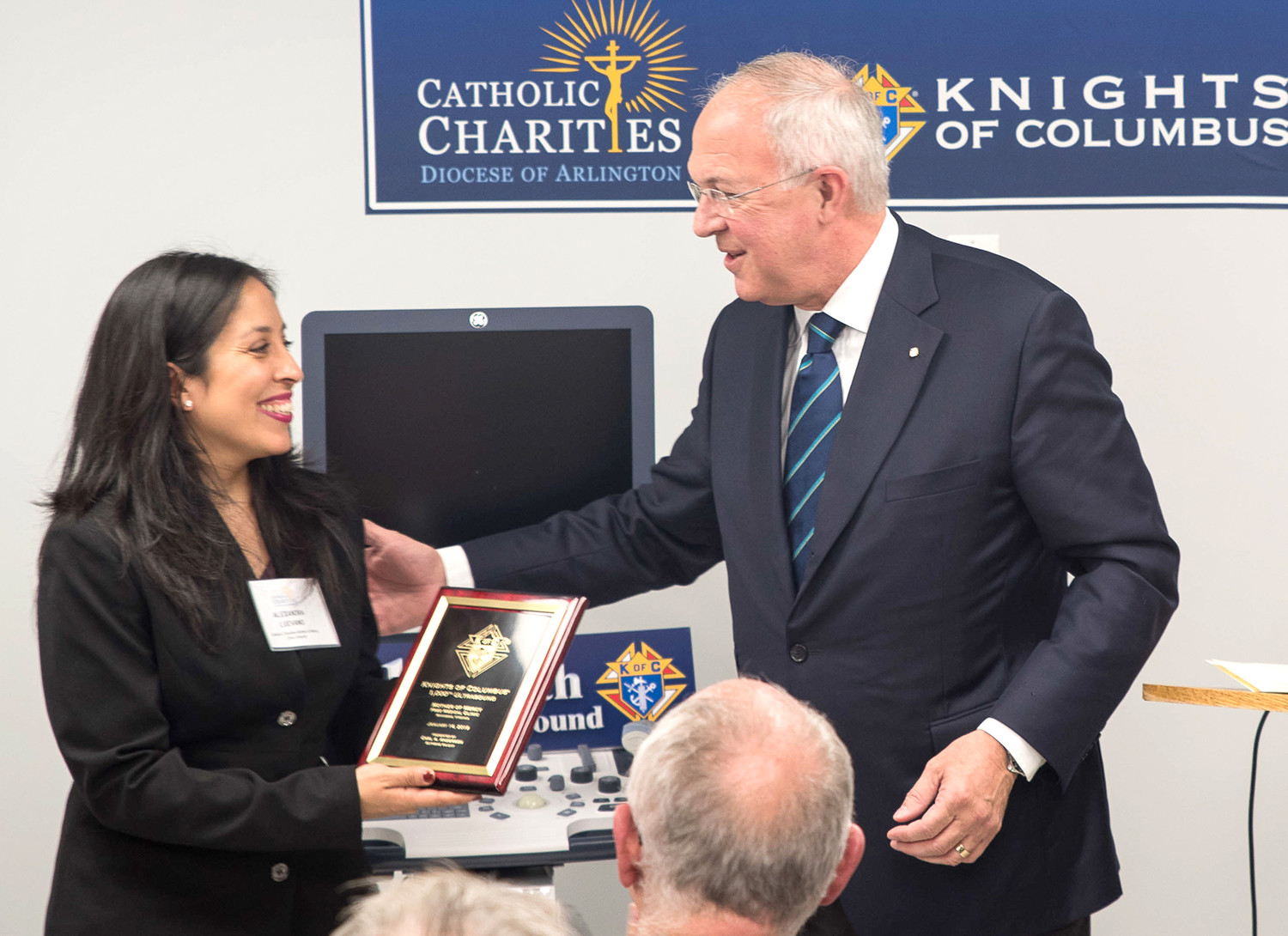 Alexandra Luevano, director of the Mother of Mercy Free Clinic in Manassas, Virginia, receives a plaque Jan. 14 from Carl Anderson, CEO of the Knights of Columbus, during the blessing ceremony of a new ultrasound machine.